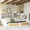 A bedroom scene featuring a white daybed with built-in shelving and drawers, decorated with pillows and a green throw blanket. Produktbild-Vorschau