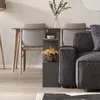A modern living room setting with a sofa, chairs, and a side table. Voir les images du produit