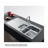 A stainless steel kitchen sink with a faucet and a draining board, set on a dark countertop. Podgląd zdjęcia produktu