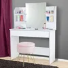 A white vanity table with a mirror and a pink stool in front of it, set against a gray wall and a purple curtain. Produktbild-Vorschau