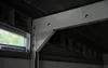 Close-up view of the internal metal frame and a small window of a Keter garden shed. Náhľad obrázku produktu