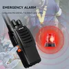 A person wearing a safety harness is in the background, with a walkie-talkie in the foreground, highlighting an emergency alarm feature with a red flashing light graphic. Produktbild-Vorschau