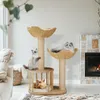 Three cats are playing on a multi-level cat tree in a living room setting with a fireplace and sofa. Náhľad obrázku produktu