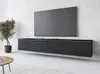 A modern living room with a wall-mounted TV bank and a large television. Náhled obrázku produktu