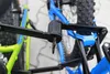 A close-up view of a bicycle lock securing two bicycles. Produktbild-Vorschau