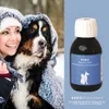 A woman and her dog are bundled up in a blanket in a snowy outdoor setting, with a product bottle placed next to them. Produktbild-Vorschau