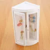 A miniature shower stall with accessories on a wooden surface. Voir les images du produit