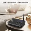 A black two-way radio sits on a round table, with musical notes floating around it. Náhled obrázku produktu