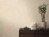 A close-up of a dark brown cabinet with decorative items on top, against a textured light beige wall. Produktbild-Vorschau