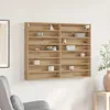 A wooden display shelf mounted on a white wall, with various decorative items placed on its shelves. Náhled obrázku produktu