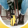 A person sitting on a stool with a shoe stretcher between their feet. Podgląd zdjęcia produktu