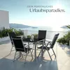 A patio set with a table and four chairs is set up on a balcony overlooking the sea. Náhled obrázku produktu