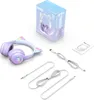 A set of ONIKUMA B90 wireless gaming headphones with cat ears, along with their packaging and accessories, laid out on a white background. Podgląd zdjęcia produktu