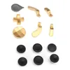 A collection of gamepad replacement parts, including joysticks, paddles, and a directional pad, laid out on a white background. Produktbild-Vorschau