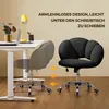 A black office chair is shown next to a white desk with a laptop and a yellow lamp. The chair is depicted in two positions, illustrating its ability to slide under the desk. Produktbild-Vorschau