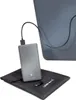 A gray power bank is connected to a laptop via a USB-C cable. A black carrying pouch and a USB adapter are placed on the surface below the power bank. Produktbild-Vorschau