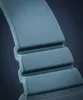 A close-up, detailed shot of a blue-gray watch strap with ribbed detailing. Produktbild-Vorschau