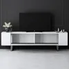 A modern white TV stand with a black television on top, set against a black paneled wall. Voir les images du produit