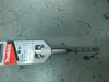 A drill bit in its packaging is placed on a gray, textured surface. Anteprima dell’immagine prodotto