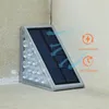 A solar-powered step light is mounted on a corner wall, with arrows indicating solar energy flow and text highlighting its features. Produktbild-Vorschau