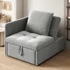 A gray sofa bed with a pillow is shown in a room setting. Náhled obrázku produktu