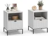 Two white nightstands with black legs, each with an open shelf and a drawer with a ribbed front. Voir les images du produit