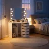 A bedroom scene with a vanity table and a bed. Voir les images du produit