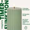 A close-up of a green LED candle with a lit flame, featuring text overlays describing its timer function and burn duration. Podgląd zdjęcia produktu