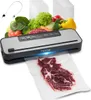 A VEVOR vacuum sealer with a variety of fresh vegetables and raw meat, along with vacuum sealing bags and a hose accessory. Produktbild-Vorschau