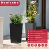 Two tall planters with plants on a patio or walkway. Produktbild-Vorschau