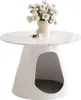 A white, conical table with a marble-effect top, featuring a cutout opening at the base that contains a gray pet bed. A vase of white flowers sits on top of the table. Produktbild-Vorschau