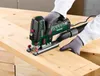 A person wearing gloves is using a jigsaw to cut a piece of wood. Produktbild-Vorschau