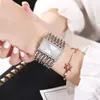 A woman's wrist wearing a silver watch and a rose gold bracelet. Produktbild-Vorschau
