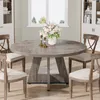 A round dining table with chairs in a well-lit room. Anteprima dell’immagine prodotto