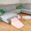 A sectional sofa with decorative pillows and pink foam play elements for children. Anteprima dell’immagine prodotto