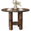 A round dining table set with plates and a vase of dried flowers. Voir les images du produit