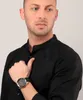 A man wearing a black shirt and a watch. Produktbild-Vorschau
