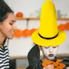 A woman smiles at a child wearing a large yellow witch hat and face paint. Produktbild-Vorschau