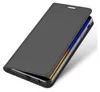 A dark gray flip case for a smartphone is shown from a diagonal angle, with the front cover partially open to reveal the phone's screen. Produktbild-Vorschau