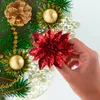 A hand holding a red glitter poinsettia decoration, part of a Christmas arrangement with pine cones and gold baubles. Produktbild-Vorschau