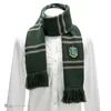 A green and gray striped scarf with a Slytherin crest is displayed on a white mannequin. Náhled obrázku produktu