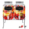 Two glass beverage dispensers filled with fruit and ice, sitting on a black metal stand. Náhľad obrázku produktu