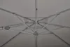 The underside of a large, light-colored umbrella, showing its metal frame and fabric. Produktbild-Vorschau