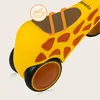 A close-up of the front wheel and body of a yellow toy with giraffe markings. Anteprima dell’immagine prodotto