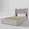 A light gray upholstered bed frame with a slatted base, shown from a side-angle against a plain background. Produktbild-Vorschau