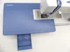 A sewing machine is placed on a blue extension table with a ruler marking. Náhľad obrázku produktu