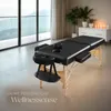 A massage table set up in a room with a large window overlooking a mountain landscape. Náhled obrázku produktu