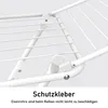 A close-up view of the white metal frame of a clothes drying rack, showing the joints and wires. Produktbild-Vorschau