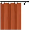 A close-up view of an orange-brown velour curtain hanging from a black curtain rod. Podgląd zdjęcia produktu