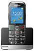 A black Maxcom MM720 SE mobile phone is shown in its charging dock. Podgląd zdjęcia produktu